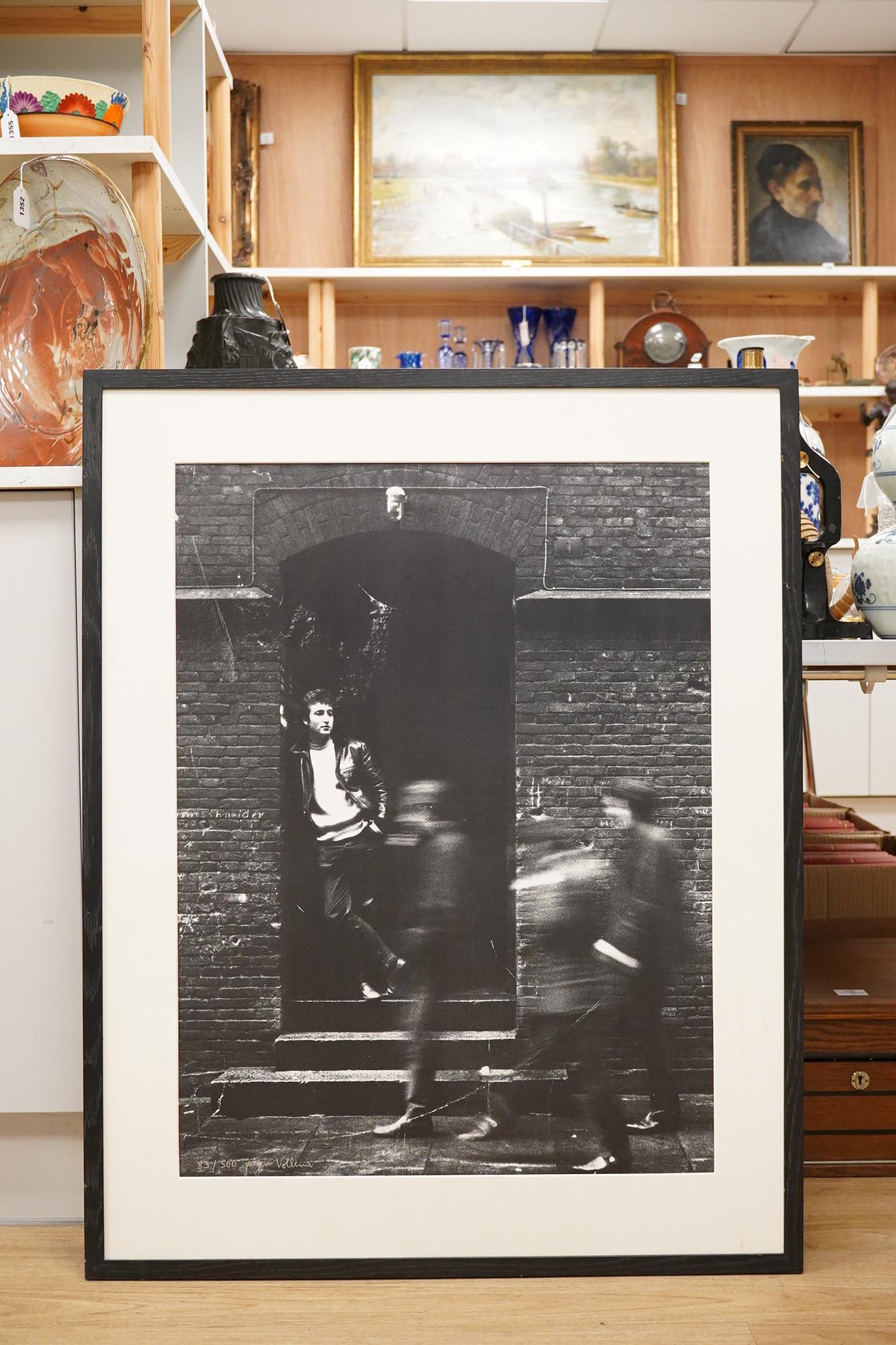 Jurgen Vollmer (German, b.1939), a framed signed limited edition lithograph 83/500 of John Lennon standing in a doorway in Hamburg (glass missing), 79 x 59cm